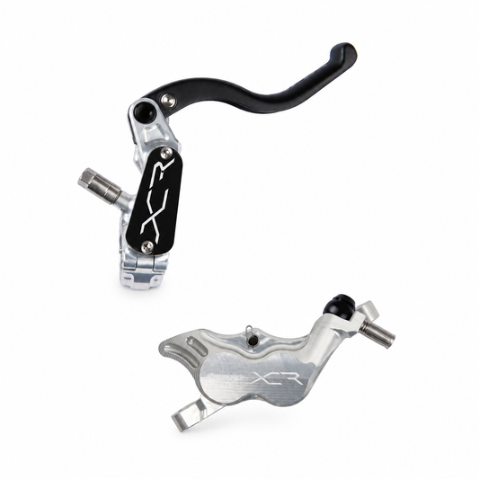 Freno HOPE XCR PRO E4 PM plateado — maneta y pinza sobre fondo blanco